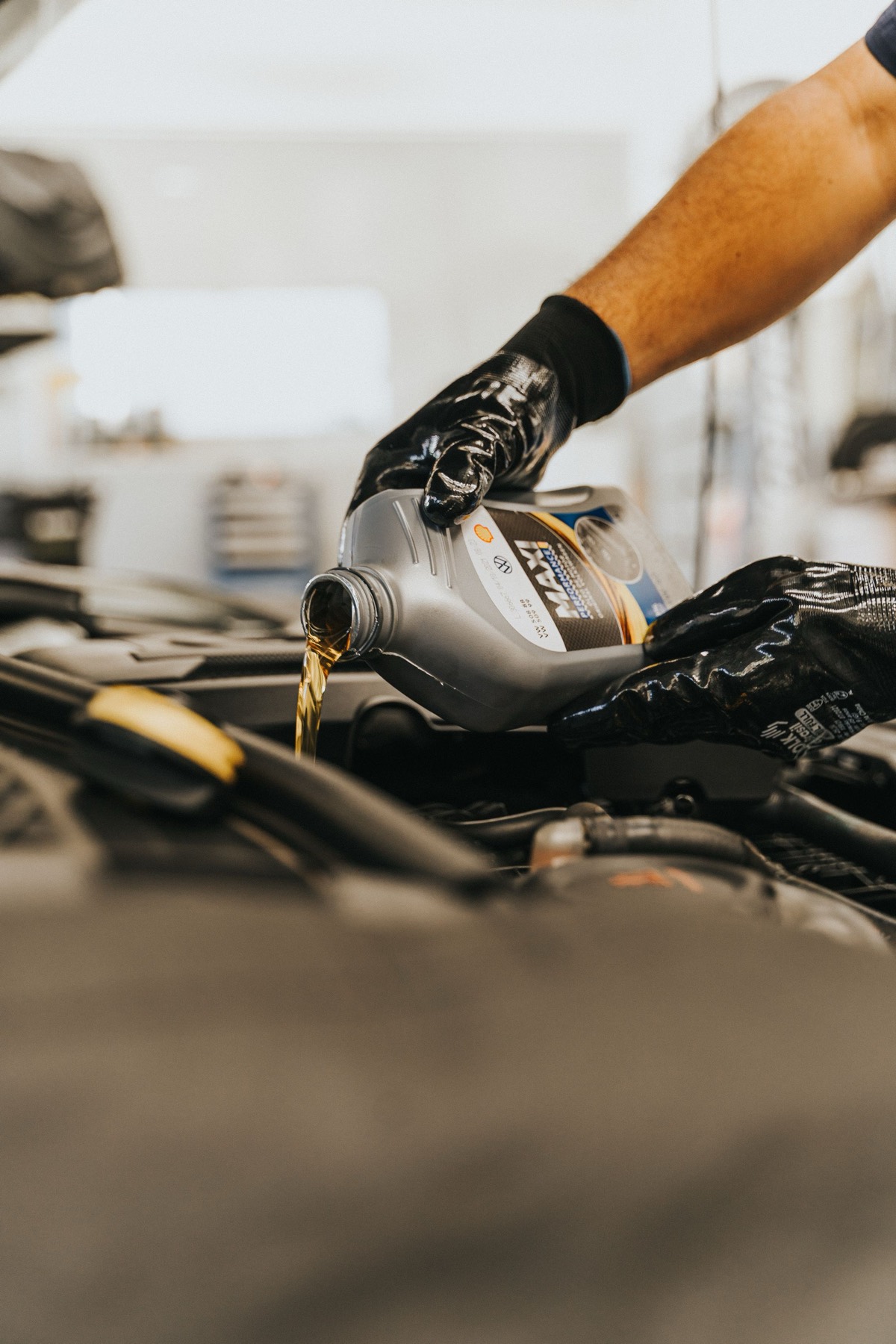 Engine oil being poured into an engine during a service